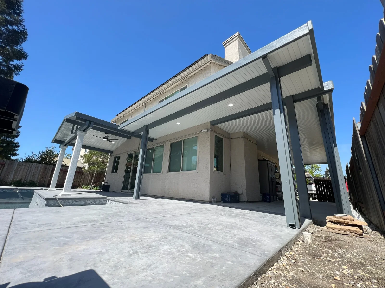 Aluminum gazebo with metal roof, ceiling fan, and concrete patio attached to home